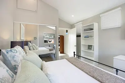 a bedroom with a bed and a living room at New with Panoramic View in Sunset Cliffs in San Diego