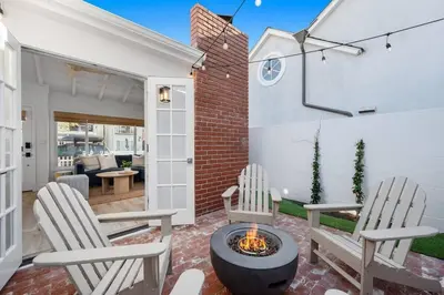 a patio with two chairs and a fire pit at Balboa Beach Getaway Steps2Sand Firepit BBQ in Newport Beach
