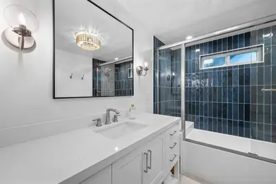 a white bathroom with a sink and a shower at Balboa Beach Getaway Steps2Sand Firepit BBQ in Newport Beach