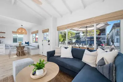 a living room with a blue couch and a table at Balboa Beach Getaway Steps2Sand Firepit BBQ in Newport Beach