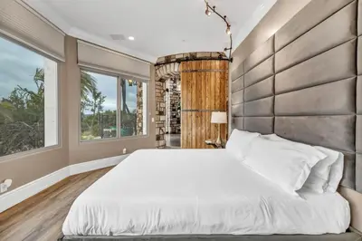 a bedroom with a large bed and a large window at Secluded Boulder Groves Resort Getaway! in Ramona