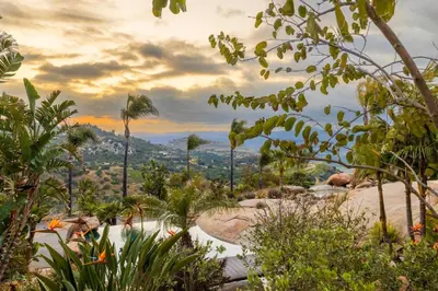a view of a mountain with palm trees and bushes at Secluded Boulder Groves Resort Getaway! in Ramona