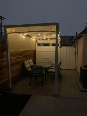 a patio with a table and chairs and lights at North Park Centrally located 8Br 5Ba House in San Diego