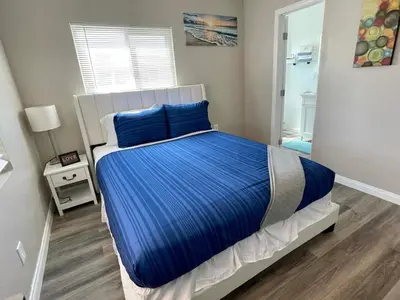 a bedroom with a large bed with blue pillows at North Park Centrally located 8Br 5Ba House in San Diego