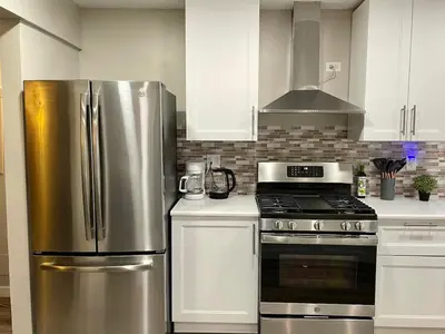 a kitchen with a stainless steel refrigerator and a stove at North Park Centrally located 8Br 5Ba House in San Diego