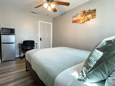 a bedroom with a bed and a ceiling fan at North Park Centrally located 8Br 5Ba House in San Diego