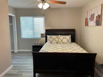 a bedroom with a bed and a ceiling fan at North Park Centrally located 8Br 5Ba House in San Diego