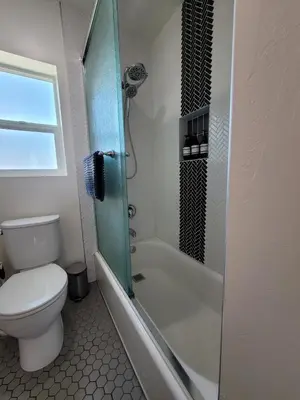 a bathroom with a toilet and a glass shower at Harborside Suite 12 with Hot Tub and King Beds in San Diego