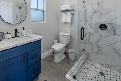 a bathroom with a toilet and a glass shower at San Diego Large Luxury home near Downtown in San Diego