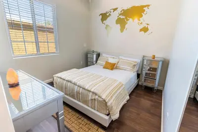 a bedroom with a bed with a world map on the wall at San Diego Large Luxury home near Downtown in San Diego