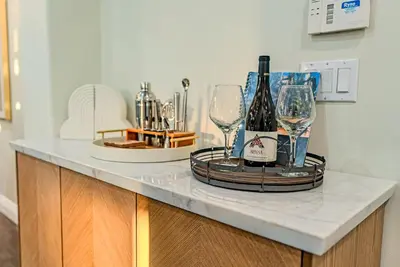 a counter with wine bottles and glasses on it at San Diego Large Luxury home near Downtown in San Diego