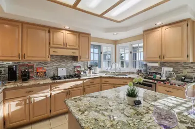 a kitchen with wooden cabinets and a granite counter top at Entire Private Home with 5 Bedrooms 4 Bathrooms, 3-Acres Estate, 3000 sqft, near Winery in Fallbrook, Available Now in Fallbrook