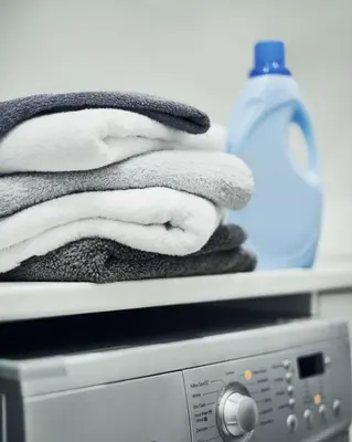 a pile of towels sitting on top of a washing machine at Entire Private Home with 5 Bedrooms 4 Bathrooms, 3-Acres Estate, 3000 sqft, near Winery in Fallbrook, Available Now in Fallbrook