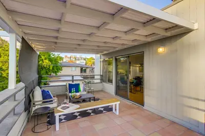 an outdoor patio with a bench and a table at Beryl Bungalow in San Diego
