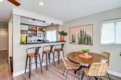 a kitchen and dining room with a table and chairs at Casa Azul Lower in San Diego