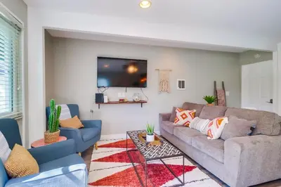 a living room with a couch and a tv at Casa Azul Lower in San Diego