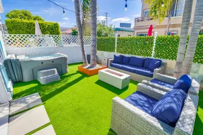 a patio with a blue couch and a sandbox at Casa Azul Lower in San Diego