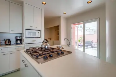 a kitchen with a stove top oven in a kitchen at Casa Rosa in San Diego