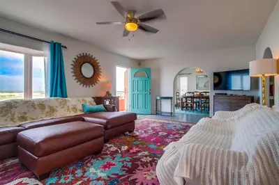 a living room with a couch and a ceiling fan at Casa Rosa in San Diego