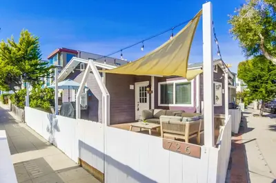 a small house with a yellow canopy on a sidewalk at Cozy Kingston 1 in San Diego