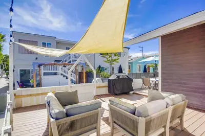 a patio with two chairs and a yellow umbrella at Cozy Kingston 1 in San Diego