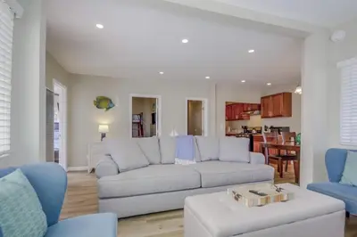 a living room with a gray couch and blue chairs at Cozy Kingston 1 in San Diego