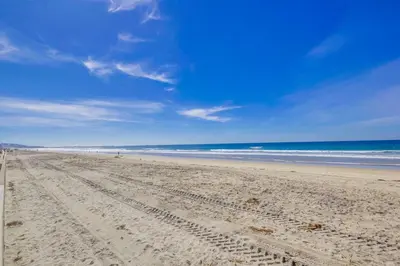 a sandy beach with the ocean in the background at Cozy Kingston 1 in San Diego