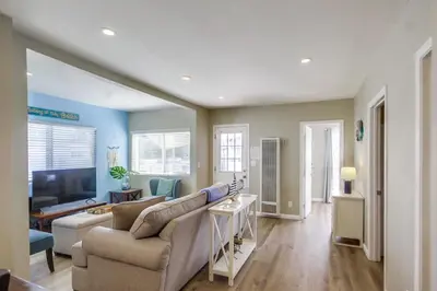a living room with a couch and a tv at Cozy Kingston 1 in San Diego
