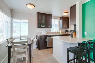 a kitchen with a table and chairs in a room at Manhattan Shores 1B in San Diego
