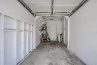 an empty garage with a white wall and a door at Manhattan Shores 1B in San Diego