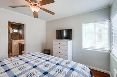 a bedroom with a bed and a ceiling fan at Manhattan Shores 1B in San Diego