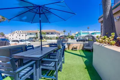 a blue table and chairs with an umbrella on a patio at Ocean Breeze 1 in San Diego