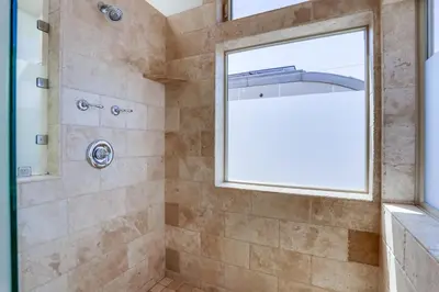 a bathroom with a shower with a window at Ocean Breeze 1 in San Diego
