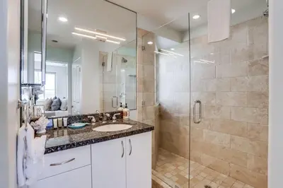 a bathroom with a sink and a glass shower at Ocean Breeze 1 in San Diego