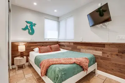 a bedroom with a bed and a flat screen tv at Ocean Breeze 1 in San Diego