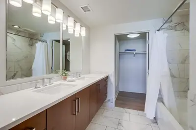 a bathroom with two sinks and a large mirror at Ocean Park 05 in San Diego