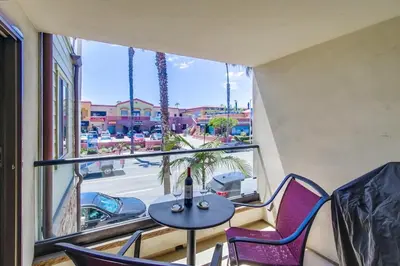a balcony with a table and chairs and a window at Pacific Paradise in San Diego