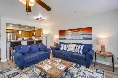 a living room with two blue couches and a table at Pacific Paradise in San Diego