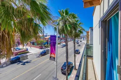 a view of a street with palm trees on a balcony at Pacific Paradise in San Diego
