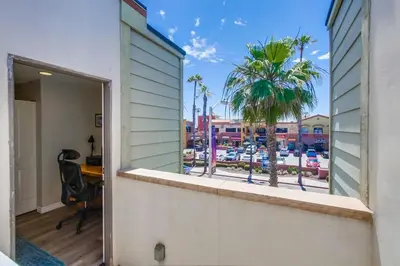 an open door to a balcony with a view of a marina at Pacific Paradise in San Diego