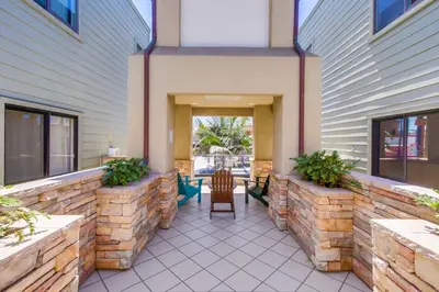 a patio with a table and a chair on a building at Pacific Paradise in San Diego