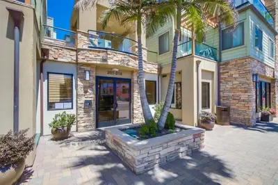 a house with palm trees in front of it at Pacific Paradise in San Diego