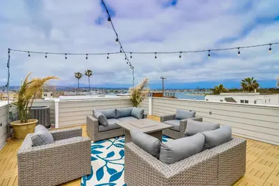 a patio with couches and a table on a deck at Seaglass Shores in San Diego