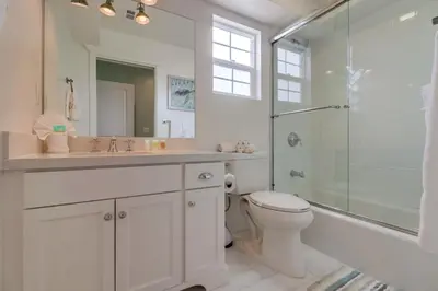 a bathroom with a sink and a toilet and a shower at Seaglass Shores in San Diego