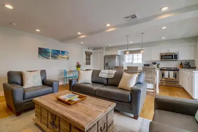 a living room with two couches and a table at Seaglass Shores in San Diego