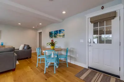 a living room with a table and chairs and a couch at Seaglass Shores in San Diego
