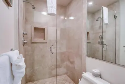 a bathroom with a shower with a glass door at Surf Rider D in San Diego