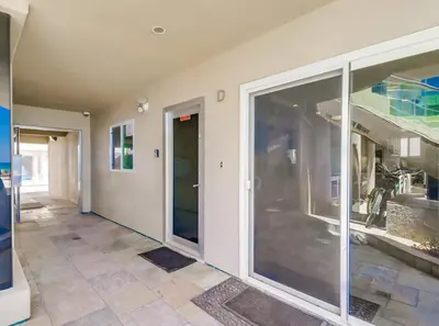 a hallway with sliding glass doors in a house at Surf Rider D in San Diego