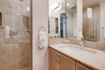 a bathroom with a sink and a shower and a mirror at Surf Rider D in San Diego