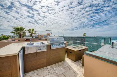 a kitchen with a stove and a balcony with the ocean at Ocean View Luxury 2 in San Diego